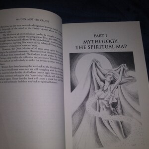 May include: A black and white illustration of a woman with long hair, wearing a flowing garment, standing with her arms raised above her head. The woman is surrounded by a swirling cloud of white dots. The text "PART I MYTHOLOGY: THE SPIRITUAL MAP" is printed in black at the top of the page.