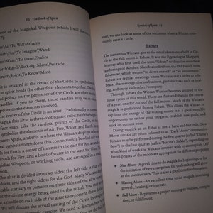 May include: A page from a book titled "The Book of Spirit" with a section on "Symbols of Spirit" and "Esbats". The text discusses the significance of the full moon in Wiccan rituals and the different types of magic that can be performed during each phase of the moon.