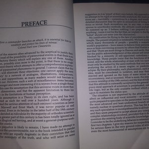 May include: A book titled "Preface" with a quote from Colonel Karl von Clausewitz about military strategy. The text discusses the possibility of paranormal events and the limitations of human perception.