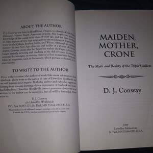 May include: A book cover with the title "Maiden, Mother, Crone: The Myth and Reality of the Triple Goddess" by D.J. Conway. The book cover is white with black text and a decorative design.