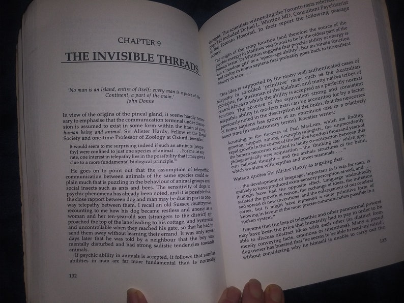 May include: Open book with a white background. The book is open to a chapter titled "The Invisible Threads." The text on the page discusses the origins of the pineal gland and the possibility of telepathy in animals. The book is part of a larger collection about the history of man.