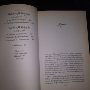 May include: A close-up of a book titled "Book Five - The Book of Air" with a preface that discusses the concept of "chi" or energy in martial arts and how it relates to magick. The book is about accessing internal energy and strength to direct your life.
