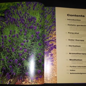 May include: A book titled "The Healing Garden" with a table of contents listing topics such as holistic gardening, feng shui, color therapy, herbalism, aromatherapy, and meditation.