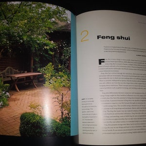 May include: A brick patio with a wooden table and bench in a lush green garden. The text "Feng shui" is visible on the page, along with the number "2".