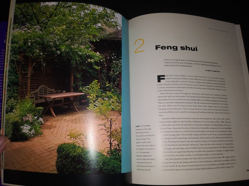 May include: A brick patio with a wooden table and bench in a lush green garden. The text "Feng shui" is visible on the page, along with the number "2".