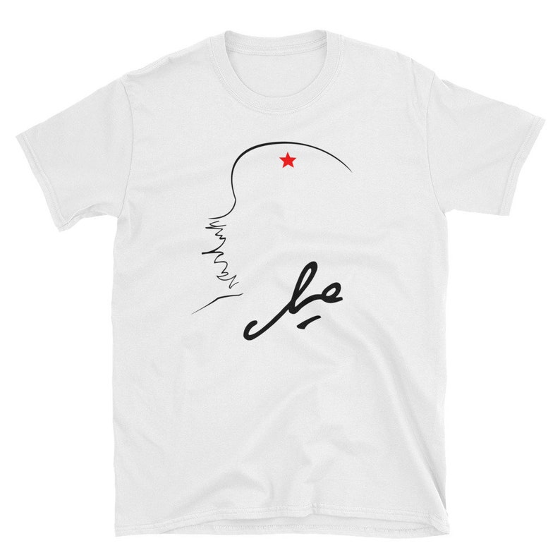 May include: White t-shirt with a black line drawing of a profile with a red star above it and the word "che" written in cursive below.