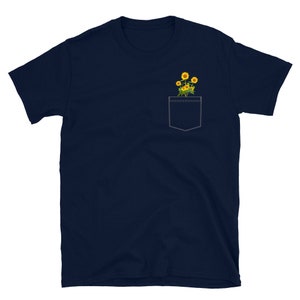 May include: A navy blue t-shirt with a pocket featuring a small bouquet of yellow sunflowers.