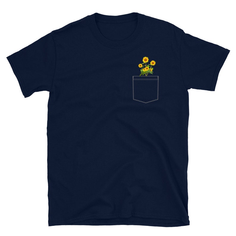 May include: A navy blue t-shirt with a pocket featuring a small bouquet of yellow sunflowers.