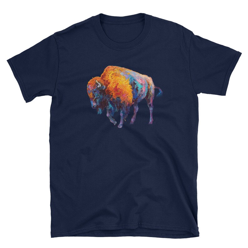 May include: A navy blue t-shirt with a colorful painting of a bison on the front. The bison is painted in shades of orange, yellow, blue, and purple.