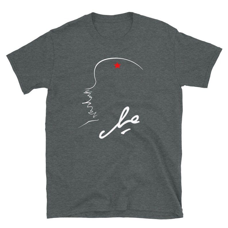 May include: A dark heather grey t-shirt with a white outline of a person's face and the word "فهد" in white Arabic script. A small red star is above the person's head.