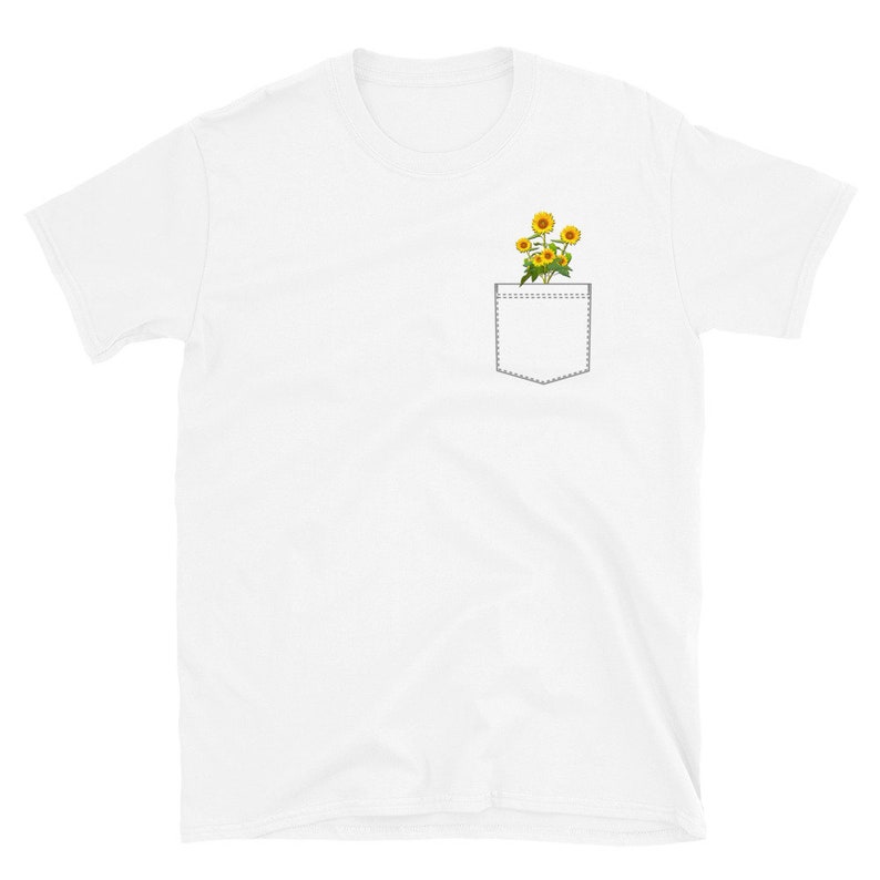May include: White t-shirt with a pocket featuring a small bouquet of yellow sunflowers.