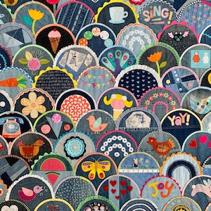 May include: A patchwork textile art piece composed of denim fabric, featuring semi-circular shapes with various embroidered and appliqued designs. Motifs include flowers, ice cream cones, birds, and the word "SING!" in yellow.