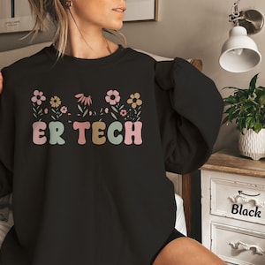 May include: Black sweatshirt with a floral design and the text "ER TECH" in colorful letters.