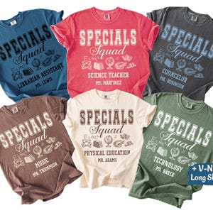 May include: A collection of six t-shirts in various colors, each featuring the text "SPECIALS Squad" in a collegiate font. Each shirt has a different title, such as "Librarian Assistant" and "Science Teacher". The shirts are available in V-necks and long sleeves.