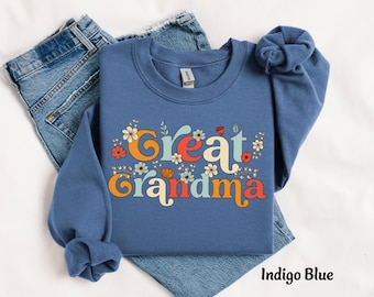 May include: Indigo blue sweatshirt with the text "Great Grandma" in colorful retro lettering and floral accents.