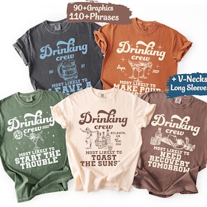 May include: Five short-sleeved crew neck t-shirts in charcoal, rust, olive green, cream, and brown. Each shirt features the text Drinking crew and unique graphics including a beer mug, martini glasses, a disco ball, bottles, and a cowboy hat.