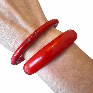 Vintage Pair Red Lucite Bangle Bracelets With One with Carving and Black Enamel (M)