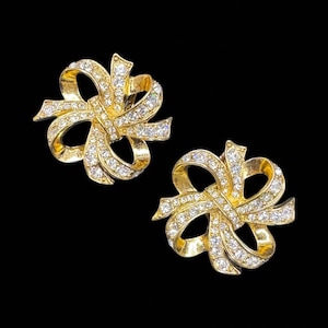 Pendientes de clip vintage KJL para Avon con lazo grueso de cristal en tono dorado brillante y diamantes de imitación