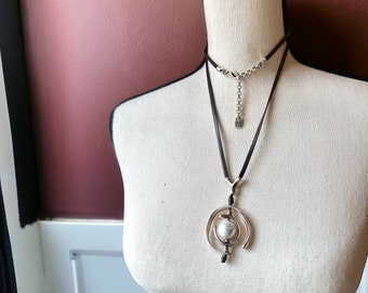 Uno de 50 Sterling Plated leather string necklace with articulating wrapped pearl 36”