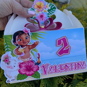 May include: A white party favor box decorated with a tropical theme. The box features a cartoon image of a girl, a pig, and a rooster. The box is decorated with the name "Valentina" and the number "2".