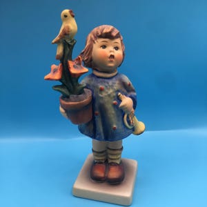 M.J. Hummel by Goebel Germany "Congraduations-Girl with Flower Pot Trumpet and Bird" #17/0 TMK-5