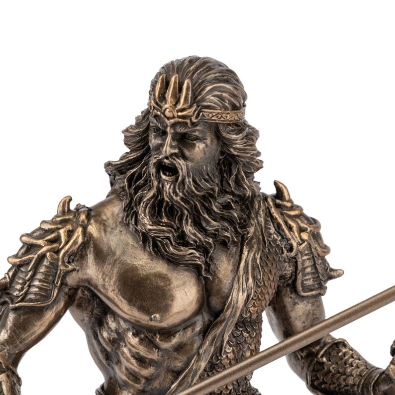 May include: Bronze-colored statue of a muscular man with a long beard, wearing a crown and armor. The statue has a stern expression and is holding a spear. The figure is a representation of a mythological god.