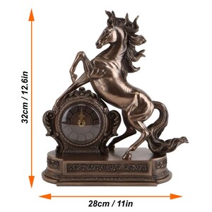 May include: Bronze-colored horse clock, 12.6 inches tall and 11 inches wide. The horse is rearing up, with its front legs raised. The clock face is round, with Roman numerals. The base has decorative scrollwork.