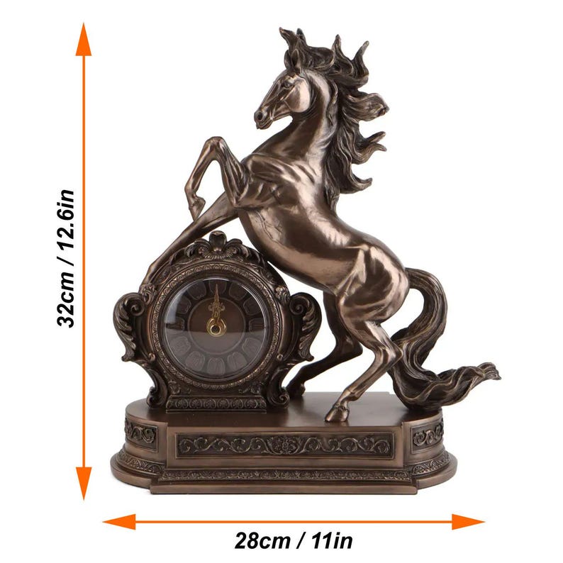 May include: Bronze-colored horse clock, 12.6 inches tall and 11 inches wide. The horse is rearing up, with its front legs raised. The clock face is round, with Roman numerals. The base has decorative scrollwork.