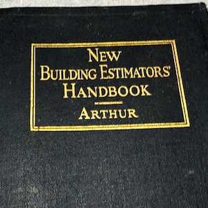 May include: A black hardback book titled New Building Estimators' Handbook by Arthur. The front cover features a rectangular gold-bordered frame containing the title and author name in gold lettering against a textured black background.