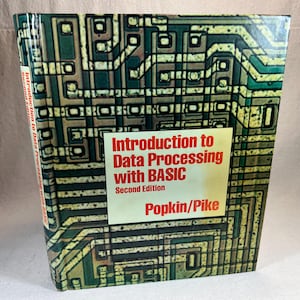 Puede incluir: Un libro vintage titulado "Introduction to Data Processing with BASIC" de Popkin/Pike. La portada del libro presenta un diseño de placa de circuito con un esquema de color verde y marrón.