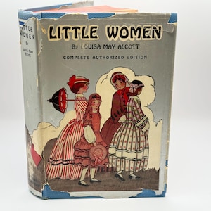 May include: A vintage hardcover book titled Little Women by Louisa May Alcott, Complete Authorized Edition. The gray cover features a color illustration of four figures in period clothing, with one holding a black parasol and another a hat.