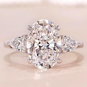 3 Carat Oval Lab Grown Diamond Ring: Pear Side Stones, Three Stone Engagement Ring