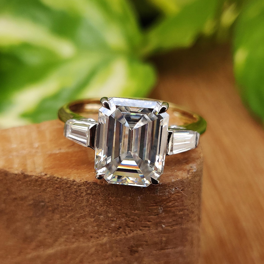 Buy Emerald and Tapered Baguette Three Stone Ring Two Tone Gold