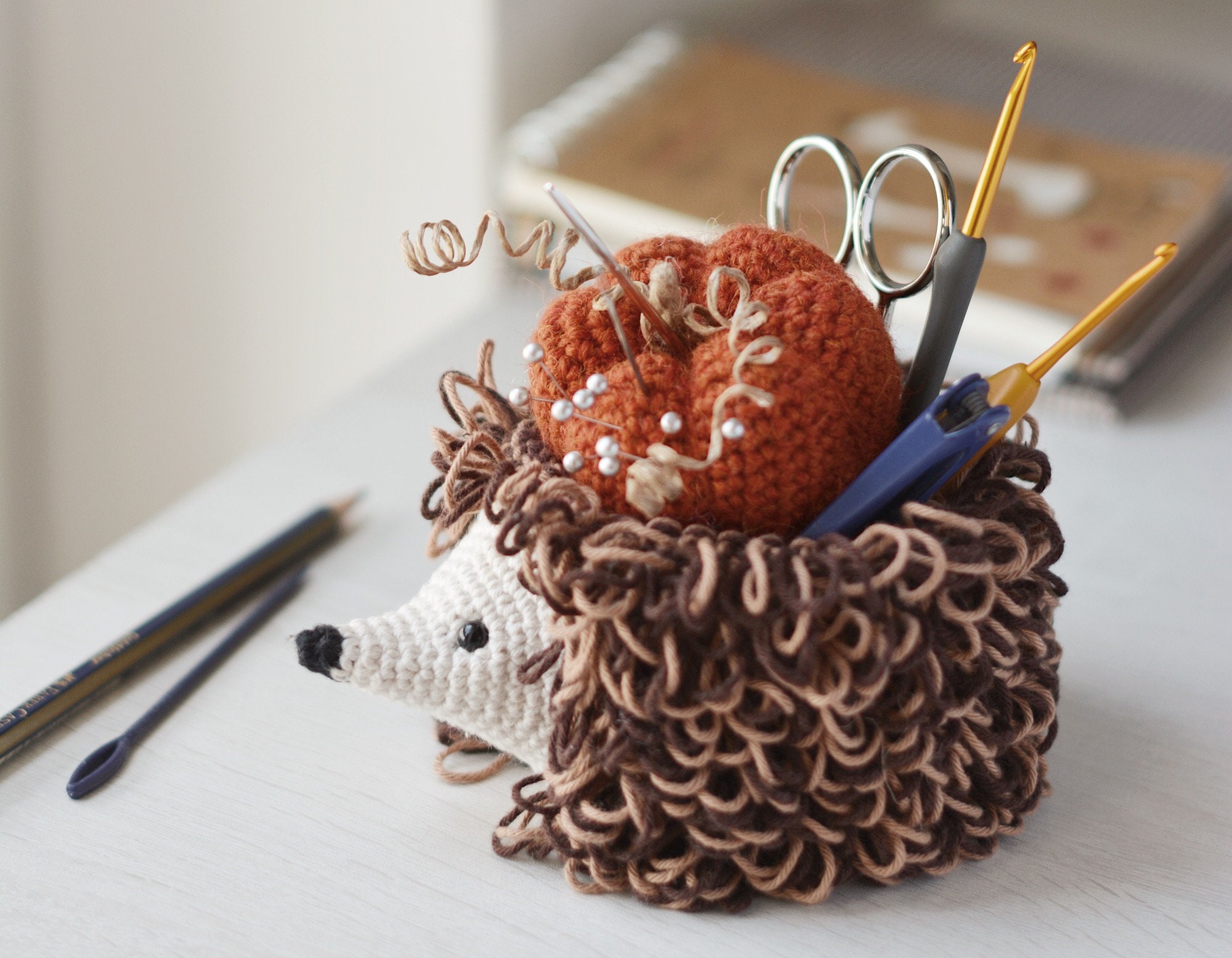 35 Hedgehog Crochet Patterns for Cute Woodland Amigurumi Gifts 21 Hedgehog Hook Holder & Pumpkin Pincushion Crochet