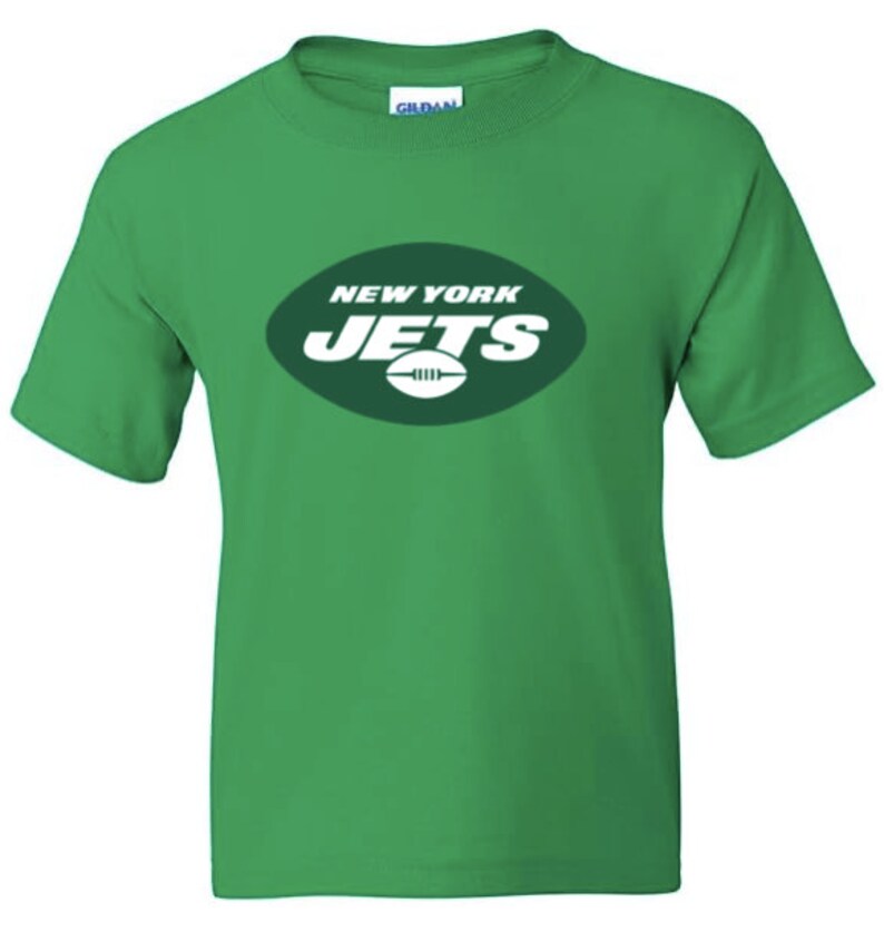 May include: Green t-shirt with the New York Jets logo in white. The logo is a green oval with the words "New York Jets" in white and a white football inside the oval.