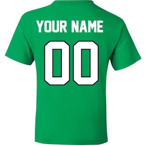 May include: Green t-shirt with white text that says "YOUR NAME" and the number "00" in a white circle with a black outline.