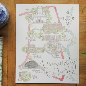 May include: A hand-drawn map of the University of Georgia campus, featuring landmarks like the chapel, the library, and Sanford Stadium. The map is drawn in a whimsical style with colorful lines and details.