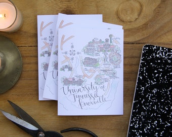 May include: A stack of white cards with a hand-drawn map of the University of Tennessee Knoxville. The map is in black and white with some color accents. The text "University of Tennessee Knoxville" is written in cursive at the bottom of the map.