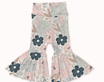 May include: White bell bottom pants with a floral print featuring pink, gray, and navy blue flowers.