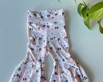 May include: White and pink baby bell bottom pants with a ghost and star pattern.