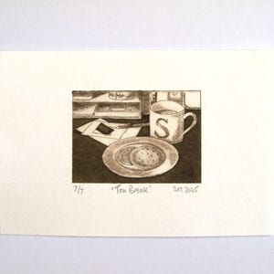 May include: A sepia-toned print depicting a tea break. A mug with the letter "S" is next to a plate with two biscuits. The words "Tea Break" and the date "SN 2025" are visible.