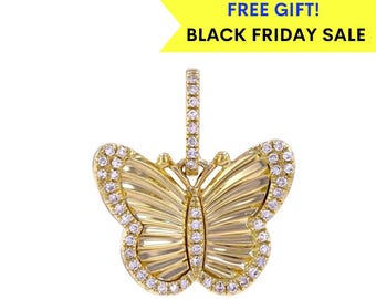 May include: A gold butterfly pendant with clear cubic zirconia stones. The pendant has a detailed design with a textured surface and a bail for attaching to a chain.