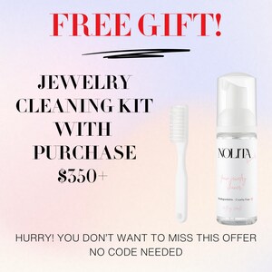 a white toothbrush next to a bottle of liquid