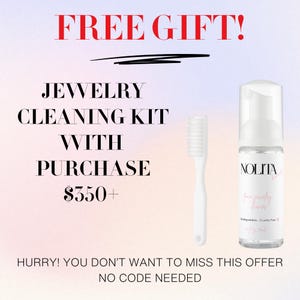 a white toothbrush next to a bottle of liquid