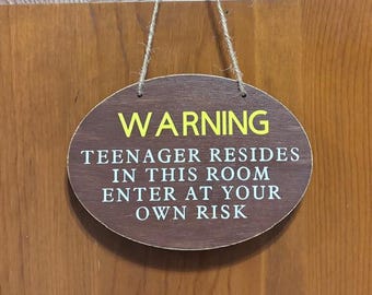 Warning Teenager resides in this room enter at you own risk. Hand painted, Vinyl lettering, door hanger, Wood. 7.5" x 5.5".