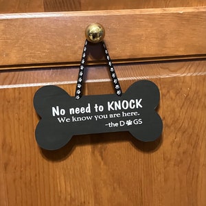 No need to knock we know you are here the dogs. Wood, Laser cut Dog Bone, Hand Painted, Vinyl Lettering, Fun Dog sign. 7.5&quot; x 3.5&quot;.