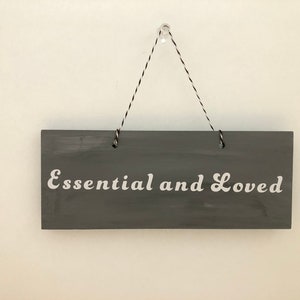 Essential and Loved. Wood, Hanging essential sign, Hand painted, Vinly lettering, great little gift. 7&quot; x 2 3/4&quot;.