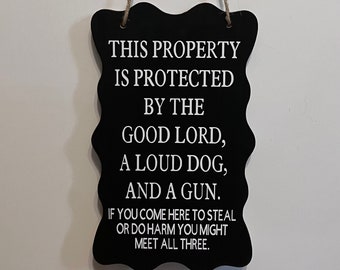 This property is protected by the good lord, loud dog, and a gun. Wood, Hand Painted, Vinyl Lettering. 7.5"x5".