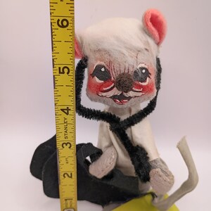 May include: A vintage stuffed mouse doll with a white head, pink ears, and a black pipe cleaner around its neck. The doll is approximately 6 inches tall. A yellow tag reads "Made only in Meredith, New Hampshire."