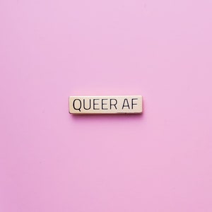 Gold Queer AF pin - This subtle lgbtq pin makes a great pride gift. A perfect gay pride accessory.